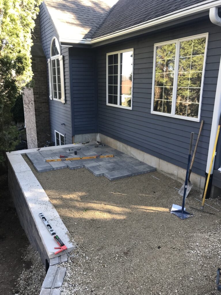 Backyard patio construction in progress with tools.